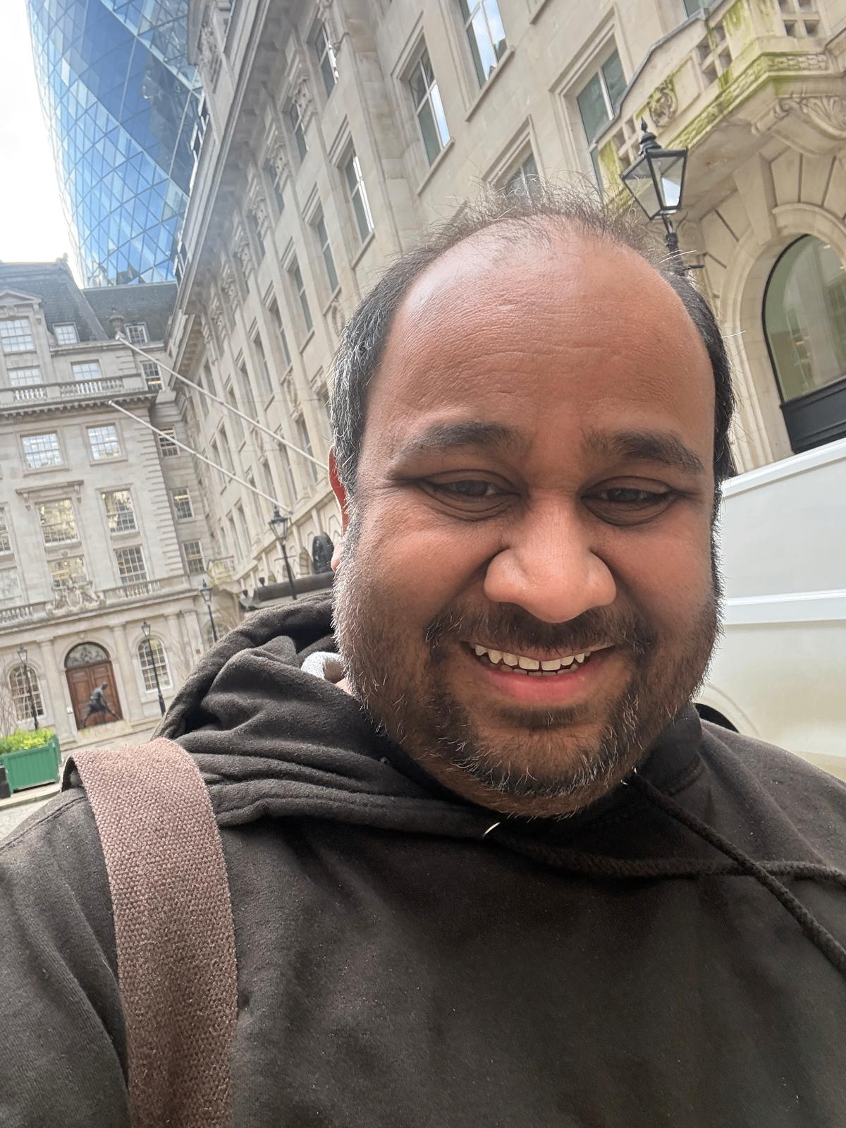 Kartikeya Roy in the City of London with the Gherkin and historic finance district buildings behind him